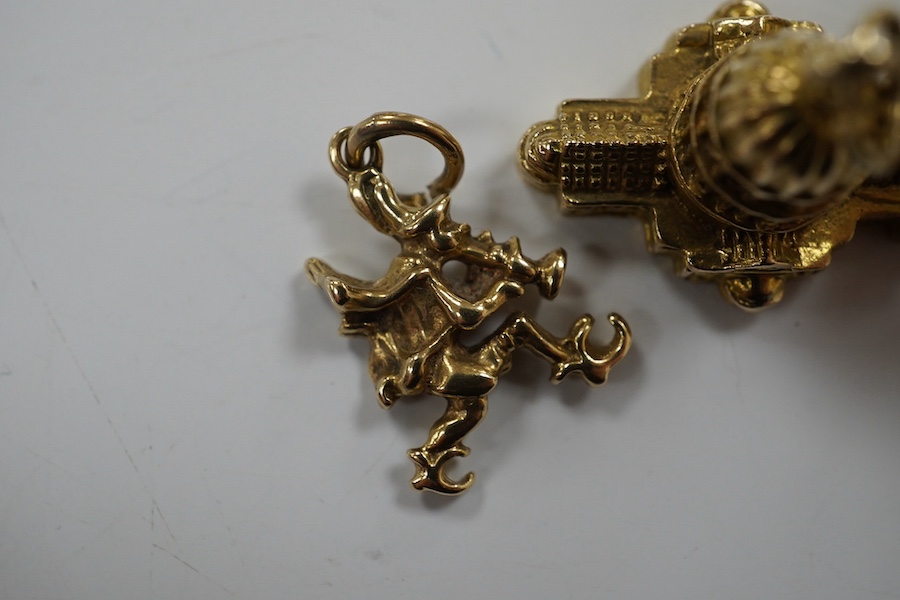 Three assorted 9ct gold charms, including Guernsey milk can and 'Ye Olde Smithy' and one other yellow metal charm, gross 14 grams. Condition - fair to good